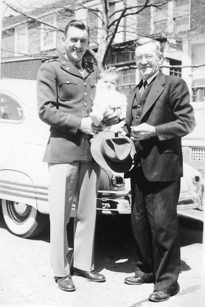 1947prints123.jpg - 1947. David J. Maloney, Sr. holds daughter, Katherine Maloney, with James Joseph Maloney at the right.