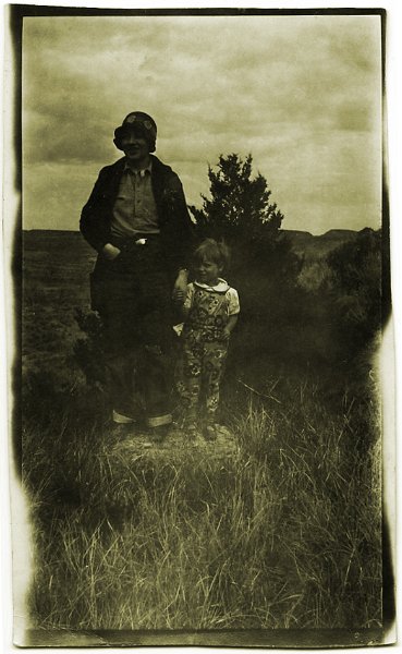 1925prints003.jpg - 1925. "This image of the two little girls, taken around 1925, shows my mother, Dorothy Janette Zeltinger, as a child holding the hand of a teacher. On the back is written, ""Toots & teacher near Medicine Rock or near Marmareth [N.D.]"" - DJM JrRegarding Medicine Rock, there is a National State Historic Site Park site there:""Located in Grant County, this site preserves an area of religious significance to Indian peoples. The site contains a large rock bearing pictographs and a circular ring of dark vegetation reputed to be the remains of a dance ring.""I've attached an image of Medicine Rock. In 1805, the Lewis & Clark expedition went to see Medicine Rock.""Two Mandan chiefs visited Fort Mandan on Feb. 21, 1805. They told William Clark that several men from their village had gone to consult a medicine stone, which was a three-day march south of the Knife River villages. The stone fostered visions. After sleeping near the stone, the men would inspect its surface for marks that would foretell the future. ""They have great confidence in this Stone and Say that it informs them of every thing which is to happen, & visit it every Spring and & Sometimes in the Summer ..., "" Clark wrote. Marmarth is a little railroad town in Western ND near the Montana border." 