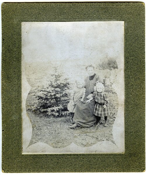 jz_032.jpg - Woman appears to be Katie Zeltinger. Children unknown. Same matting as previous photo of a field cook wagon and  as the previous photo of Matt Zeltinger with two unknown boys.