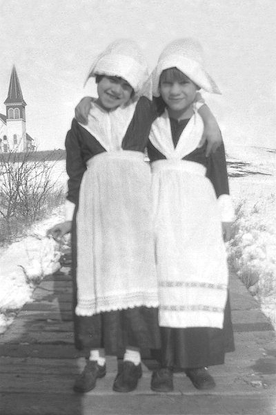 zeltinger031.jpg - 1928. "This picture is of my Mom, Dorothy Janette ""Jane"" Maloney (right) with a friend - perhaps participating in a childhood program celebrating family ancestry? Is that a Swedish costume? Mom's grandmother was Victoria Westerstrom. " DJM Jr""I'm going to take a stab at this. The snow in the background could have been around Thanksgiving. The girls may be dressed as pilgrims. Darling photo of your Mom!"" - Diane Brady