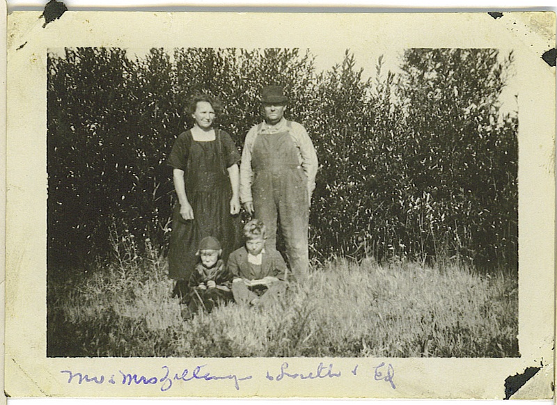 ldz_16.jpg - Inscribed on reverse, "Taken on the west side of the house. The willows are tall around the pond." Katie and Ignatius Zeltinger with children Loretta and Ed, c. 1922