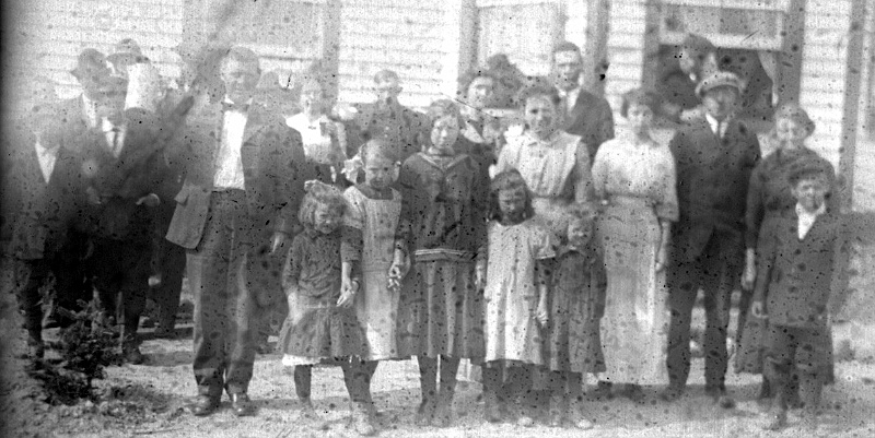 zeltinger004.jpg - Glass plate negative from Mathias Zeltinger estate; John Zeltinger farm house south of Tolley, ND.  Probably members of the John Zeltinger family and the Kirsch family. The very slender young woman is probably Lena Dahinden, Grandpa Zeltinger's half-sister.