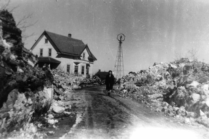 zeltinger068.jpg - Ignatius and Katie Zeltinger farm near Tolley, ND after bad blizzard of 1947; photo taken in March 1947 after bulldozer opened driveway; Eunice walks in the driveway.